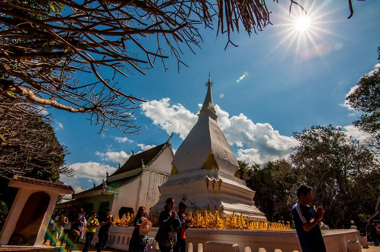 พระธาตุศรีสองรัก อำเภอด่านซ้าย เจดีย์สีขาวมียอดเรียวและผู้คนไหว้ตรงลานด้านหน้า ภาพจาก Wikimedia Commons ผู้ถ่าย Masterpoy สัญญา CC BY-SA 3.0 ไม่ระบุวันที่ถ่าย